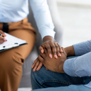 Close up shot of a therapist reassuring a patient